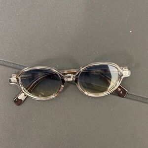 Transparent Oval Sunglasses with Dark Lenses